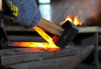 Blacksmith with hot iron