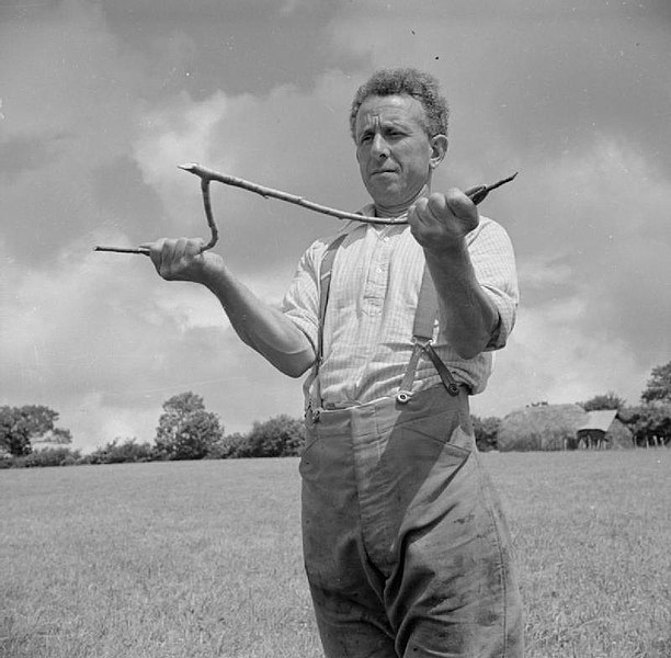 Farmer with dowsing rod